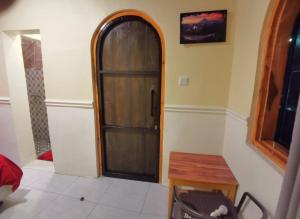 una puerta de madera en una habitación con mesa en Tube Bromo Homestay en Probolinggo