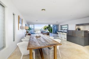 una cucina e una sala da pranzo con tavolo e sedie in legno di Sapphire Sands a Sapphire Beach