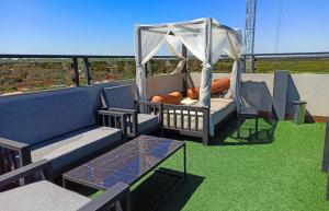 a patio with a gazebo and a swing at Bello monoambiente a metros del aeropuerto in Colonia Mariano Roque Alonso