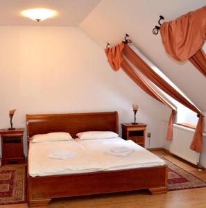 a bedroom with a bed in a attic at Penzion Scarlet in Trenčín