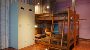 a bunk bed room with two bunk beds and a ladder at Lovely Bean Hostel in Hualien City