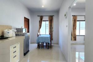 a kitchen with white walls and a table in it at Garden house in Aonang in Krabi town