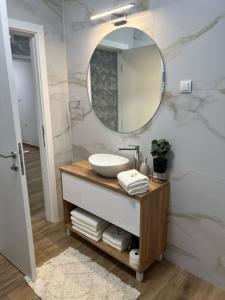a bathroom with a sink and a mirror at Centar NS 5 in Novi Sad