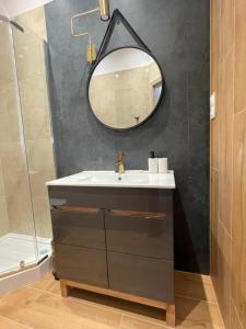 a bathroom with a sink and a mirror at Aparthotel Cracow in Kraków