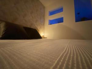 a bedroom with a bed with a white comforter at La Lunita in Valverde