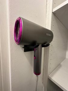 a hair dryer hanging on a wall with a purple light at Ocean Waves - Alykes Beach in Drosia