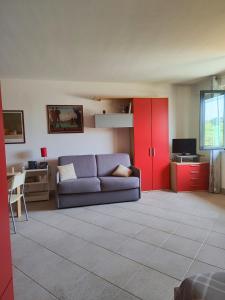 a living room with a couch and a red cabinet at Agape in Marco Simone +21 photos