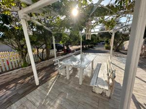 a white table and chairs under a pergola at Ocean Waves - Alykes Beach in Drosia