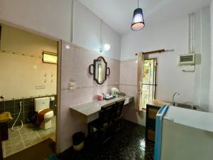 a bathroom with a sink and a toilet and a mirror at Baan Soontree Resort in Chiang Rai