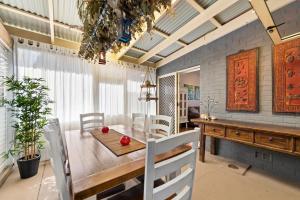 a dining room with a wooden table and chairs at Fingal Pines Getaway, Apartment in Fingal Bay