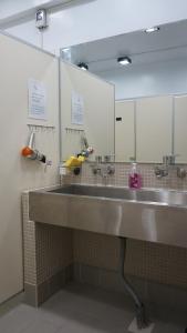 a bathroom with two sinks and two mirrors at Lovely Bean Hostel in Hualien City