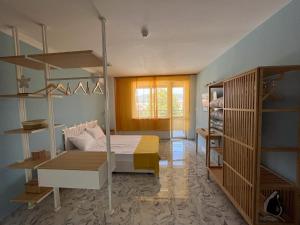 a bedroom with a bed and shelves in a room at Summer H. Studio Sunny Beach in Sunny Beach