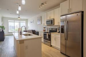 a large kitchen with a stainless steel refrigerator at Upscale Apartment on RiverWalk in San Antonio