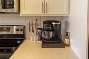 a coffee maker on a counter in a kitchen at Upscale Apartment on RiverWalk in San Antonio
