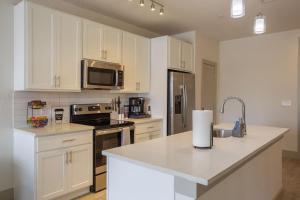 a kitchen with white cabinets and a counter top at Upscale Apartment on RiverWalk in San Antonio