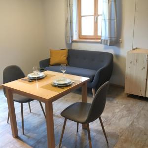 a living room with a table and a couch at Büchlhof - App. Breitenstein in Lilienfeld