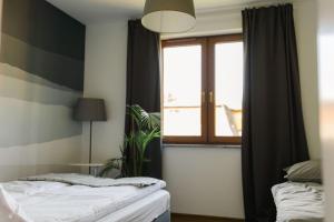 Posteľ alebo postele v izbe v ubytovaní Villa Monica Apartamenty