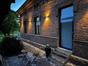 a brick building with a table and chairs in front of it at Loft Suite in Lappeenranta