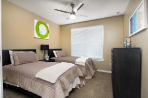 a bedroom with two beds and a ceiling fan at Private 2BR APT Downtown By RiverWalk in San Antonio
