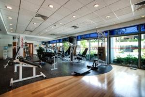 a gym with treadmills and machines in a room at Republic of Singapore Yacht Club in Singapore