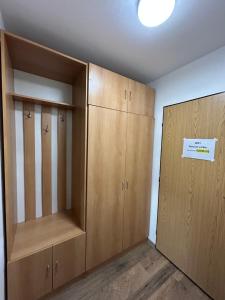an empty room with wooden cabinets and a white sign at Penzion u Fika in Ostrava