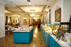 a buffet line in a restaurant with food on display at Ichan Qal'a Premium Class Hotel in Tashkent