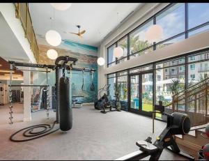 a gym with treadmills and exercise equipment in a building at Huge 2bd Apt Near Disneyland &Anaheim Conv Center 3Tofv in Anaheim