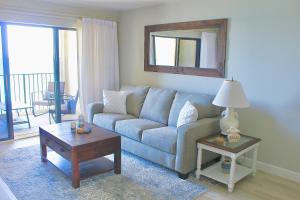 a living room with a couch and a table at Ocean Breeze Condo in Jensen Beach +27 photos
