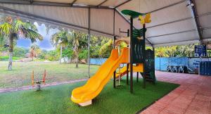 a playground with a slide in a tent at Wet Spot Amusement Water Themepark Family Suite - Enjoy Biggest Water Themepark Fun in Melaka Town in Malacca