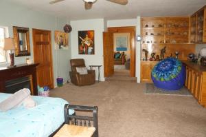 a bedroom with a bed and a living room at Lunar Eclipse on 4 acres w hot tub in Yucca Valley