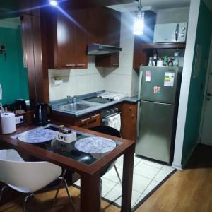 a kitchen with a wooden table and a green refrigerator at Departamento Santiago Centro in Santiago