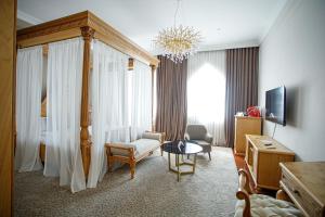 a hotel room with a bed and a living room at Ichan Qal'a Premium Class Hotel in Tashkent