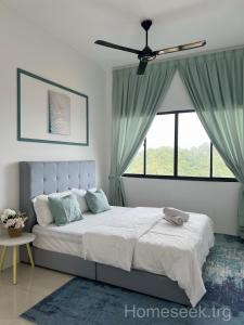 a bedroom with a bed with a ceiling fan at Homeseek, Spacious and Cozy Apartment in Kuala Terengganu in Kuala Terengganu