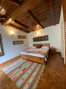 a bedroom with a bed and a rug on the floor at Villa Bliss Nest in Nainital
