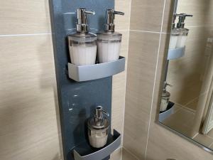 a drink dispenser in a bathroom with a mirror at Ocean Front SUMUIDE in Nago +64 photos