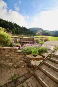 a garden with a stone staircase and flowers at Chalet Apartment Leogang in Leogang