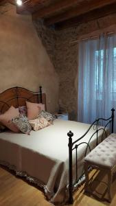 a bedroom with a bed and a chair and a window at Appartamento Il Vicoletto in La Spezia