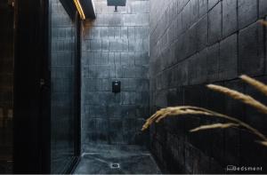 a dark hallway with a door and a wall at Bedsment in Chiang Rai +16 photos