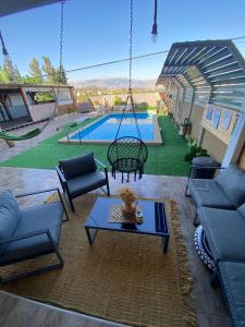 a patio with a swing and a pool at חלומות סיגלית בקריית שמונה in Qiryat Shemona