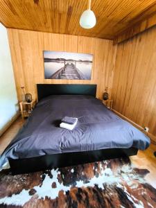 Un dormitorio con una cama con un libro. en Spacieux T2 à 100m des pistes & WIFI ultra rapide, en Saint-Chaffrey