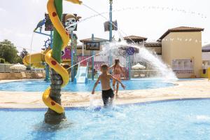 a young boy playing in a water park at Atlantica Aeneas Resort in Ayia Napa