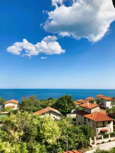 a group of houses on a hill with the ocean at Panorama Pearl in Balchik