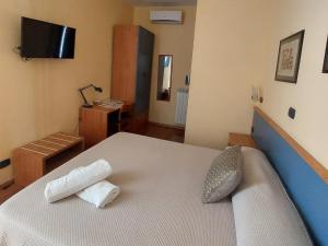 Ένα ή περισσότερα κρεβάτια σε δωμάτιο στο Domus Cesare