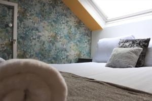 a bedroom with a large bed with a window at Westbourne - Spacious 4 bed flat with free parking in Gateshead