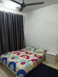 a bedroom with a bed and a curtain at Alanis Residence@KLIA in Sepang