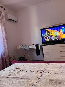 a bedroom with a bed and a tv on a dresser at Holiday Home in Vlorë