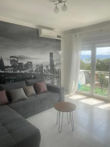 a living room with a couch and a table at Apartments Tepavac in Novi Vinodolski