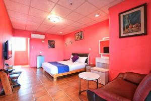 Rúm í herbergi á Fumigate Hotel