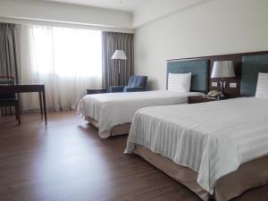 Postel nebo postele na pokoji v ubytování CHECK inn Taipei Neihu