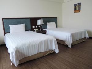 Postel nebo postele na pokoji v ubytování CHECK inn Taipei Neihu